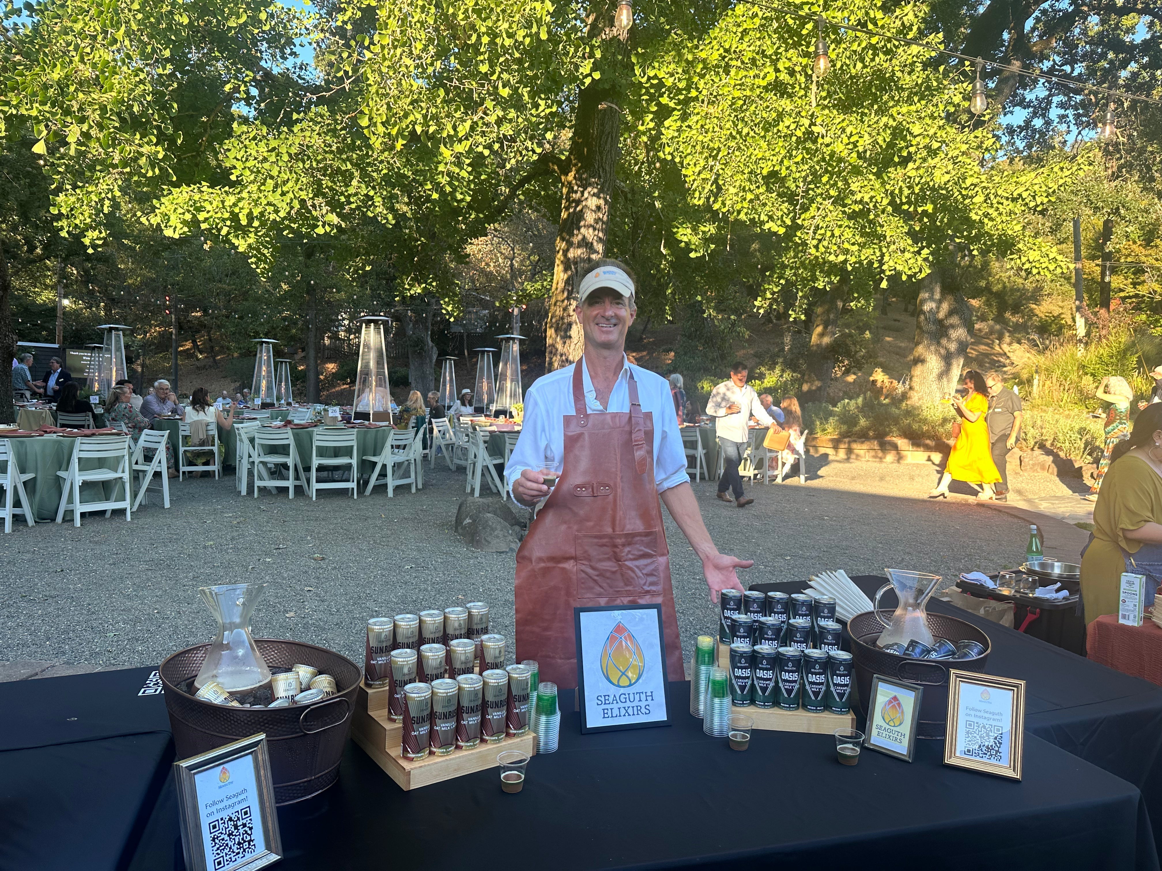 Geoff Broll serves adaptogenic coffee at an event, Outseide, tress, sunshine